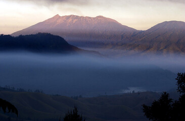 Beautiful view in the morning in the mountains, white mist blankets nature and the sunrise shines