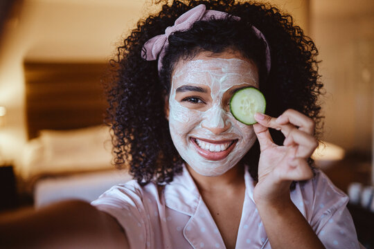 Portrait, selfie and cucumber with woman for mask, happy and smile with facial, skincare or grooming in bedroom. Face, fruit and photo by girl relax with raw, vegan and eco product for skin detox
