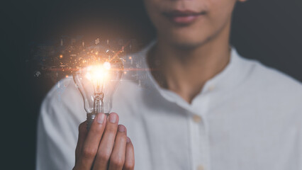 a light bulb in a man's hand,concept with innovation and inspiration, innovative technology in science concept and modern business development,creative idea,marketing strategy planning.