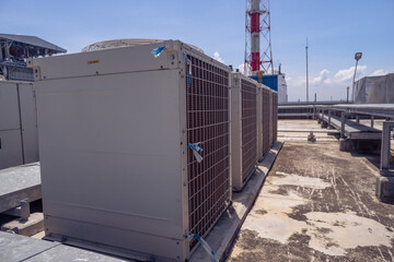 Array of outdoor fan air conditioner on the roof top building. The photo is suitable to use for construction and maintenance of air conditioner.