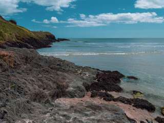 Fototapeta na wymiar Cape of the Virgin Mary on a sunny day. The rocky Irish coast, rock formation near body of water.