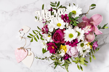 Happy Mothers Day background with dainty flowers. Beautiful greeting card. Holiday concept. View from above.