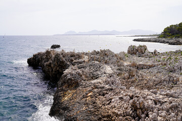 Juan-les-Pins stones rocks path access to sea beach in Antibes France south east