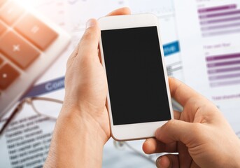 Hands hold a phone with a blank screen