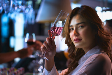 Closeup of pretty woman and pink cocktail in her hand and she hangout in the party night bar