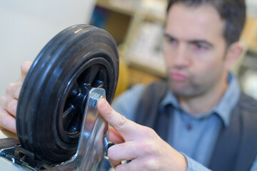assembler aligning the trolley wheel