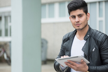 University student using digital tablet in campus School, Bavaria, Germany