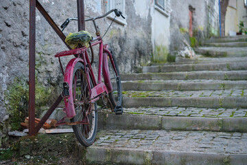 Old bike on the street in the old town, selective focus. Cozy old street idea for decor and interior design.