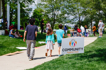 A father and children walk towards group of people at protest