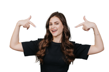 Attractive brunette young woman with wavy long hair points at herself by index fingers, looks at camera, toothy smiles over transparent background. Italian girl satisfied by healthy lifestyle. Blogger