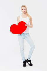 Portrait, heart and valentines day with a woman in studio on a gray background for love, dating or...