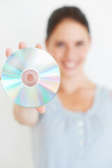 Vintage, music and hand of woman with cd in studio showing nostalgic, fun and old fashioned entertainment with mockup. Hands, dvd and girl presenting shiny disc, copy space and isolated mock up