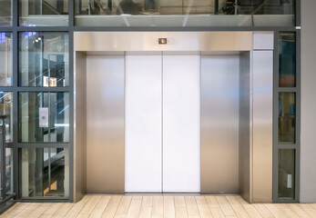 Front view of elevator with closed doors in lobby, shopping mall, office building or condominium