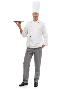 Portrait of chef holding empty tray, menu special and smile presenting promo deal or restaurant product placement. Happy full body cook man in uniform, mock up isolated on white background in studio.