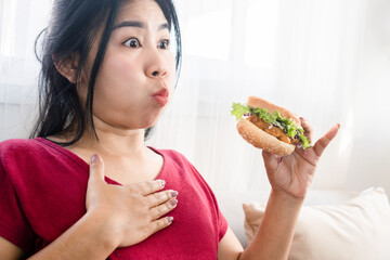 Asian woman accident chocking on food and can't breathe while eating a burger that stuck in the...