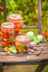 Healthy and tasty pickled tomatoes in summer greenhouse