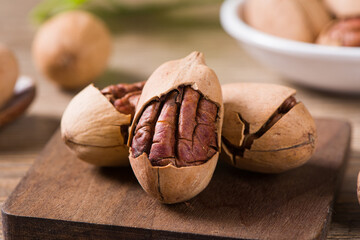 close up of pecan nuts on wooden table