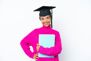 Young student hispanic woman holding a books isolated on white background posing with arms at hip and smiling