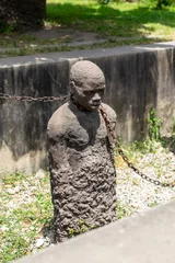 Foto op Plexiglas Sculpture of slaves dedicated to victims of slavery in Stone Town of Zanzibar © Sebastian
