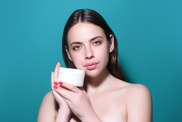 Woman putting cosmetic cream. Spa model applying skincare product on her face. Morning make-up. Moisturizing skincare cream, lotion or mask for skin lifting and anti-aging effect.
