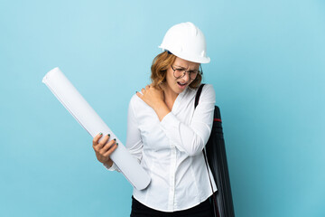 Young architect Georgian woman with helmet and holding blueprints over isolated background suffering from pain in shoulder for having made an effort