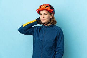 Young cyclist woman isolated on blue background having doubts