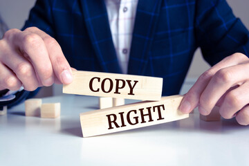 Obraz premium Close up on businessman holding a wooden block with 