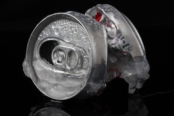 crumpled aluminum can isolated on black