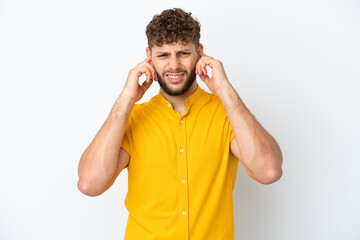 Fototapeta premium Young handsome caucasian man isolated on white background frustrated and covering ears