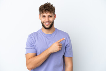 Young handsome caucasian man isolated on white background pointing to the side to present a product
