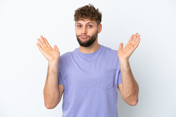 Young handsome caucasian man isolated on white background making doubts gesture