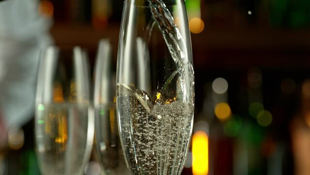 Super slow motion of pouring champagne into glass with speed motion. Filmed on high speed cinema camera, 1000 fps, placed on high speed cine bot.