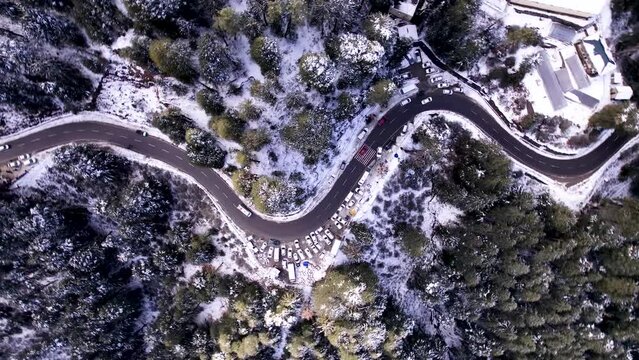 Birds eye view of snow covered road and forest,road between snowy forest