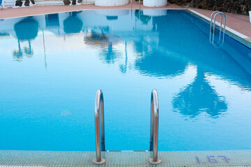 Pool ladder somewhat deteriorated by pool products in the foreground