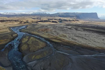 Fotobehang mountains over river and ice from aerial view © Cavan