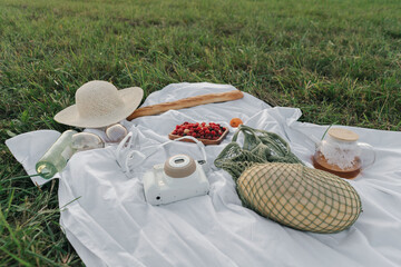 Tablecloth with fruits, picnic food, hat