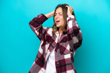 Young caucasian woman isolated on blue background stressed overwhelmed