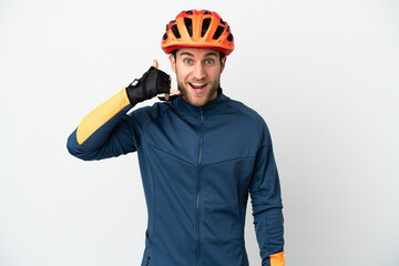 Young cyclist man isolated on white background making phone gesture. Call me back sign