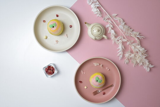 traditional Chinese vegetarian teochew crispy cute color pink and yellow yam mooncake on plate in white and pink color background