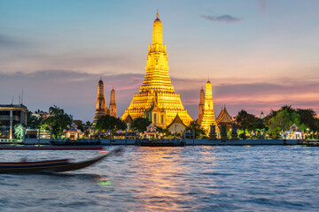 Naklejka premium Wat Arun ,lit up after sunset,along the Chao Phraya river,Bangkok,Thailand.