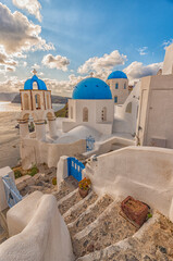 View on the picturesque church with the three blue domes, Santorini island GR