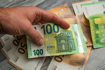 euro money with different denominations in hand - obrazy, fototapety, plakaty