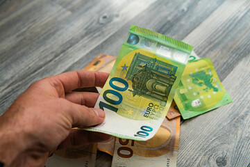 euro money with different denominations in hand
