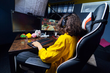 Young teenage girl playing on computer. Pretty girl gamer having fun with computer. © Vadim