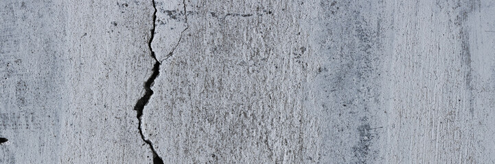 Obraz premium Texture of old cracked concrete wall. Rough gray concrete surface. Wide panoramic background for design.