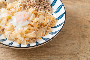 dried spicy noodles with minced pork, meatballs and egg