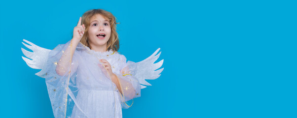 Child angel pointing up, point gesture. Valentines day banner. Cute child with angel wings. Wide banner panoramic header copy space. Studio portrait of angel child.
