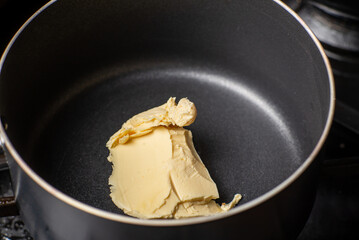 Melt the butter in a saucepan. The initial stage of preparing the sauce