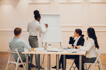 Arabic businessman holding a meeting to his diverse colleagues in an office