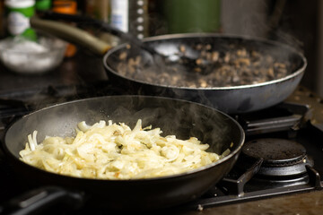 Roasting onions. Chopped onions are fried in a pan. Cooking food.